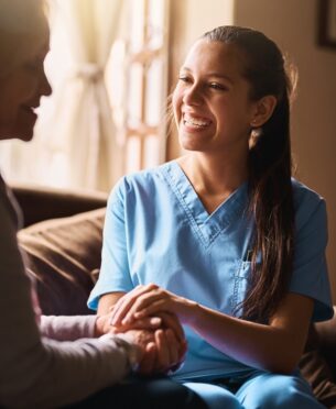 Cropped shot of a nurse holding a senior womans hands in comfort.